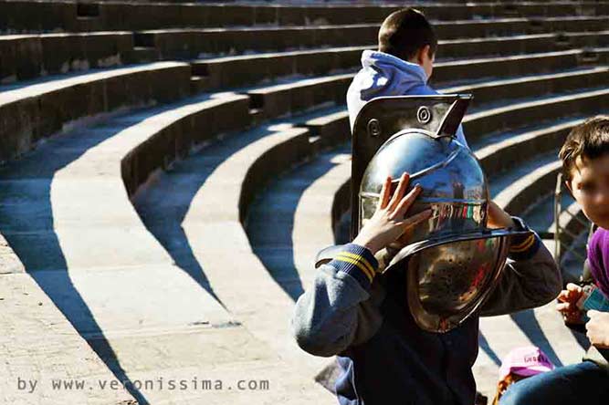 A boy playing the gladiator in Verona amphitheater